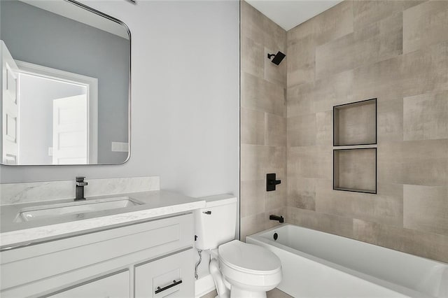 full bathroom featuring vanity, toilet, and tiled shower / bath