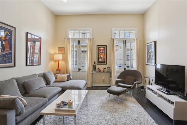 living room featuring dark wood-type flooring and french doors