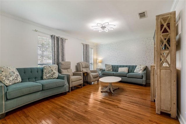 living room with hardwood / wood-style flooring and crown molding