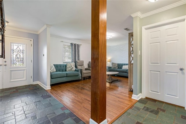 entrance foyer with decorative columns, ornamental molding, and dark wood-type flooring