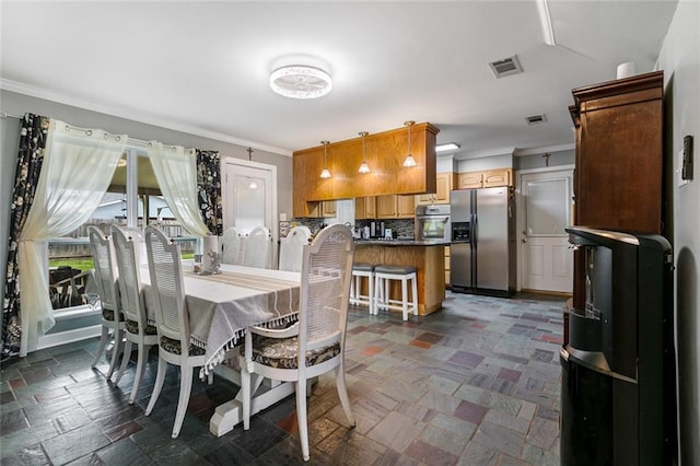 dining space featuring ornamental molding