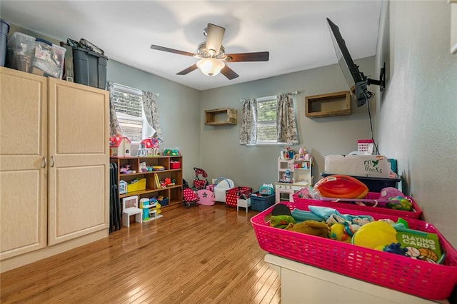 game room featuring a wealth of natural light, light hardwood / wood-style floors, and ceiling fan