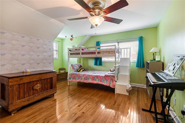 bedroom with light hardwood / wood-style floors, multiple windows, and ceiling fan