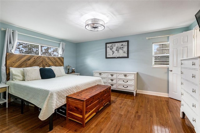 bedroom with dark hardwood / wood-style flooring