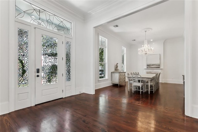 foyer featuring a chandelier, dark wood-type flooring, and crown molding