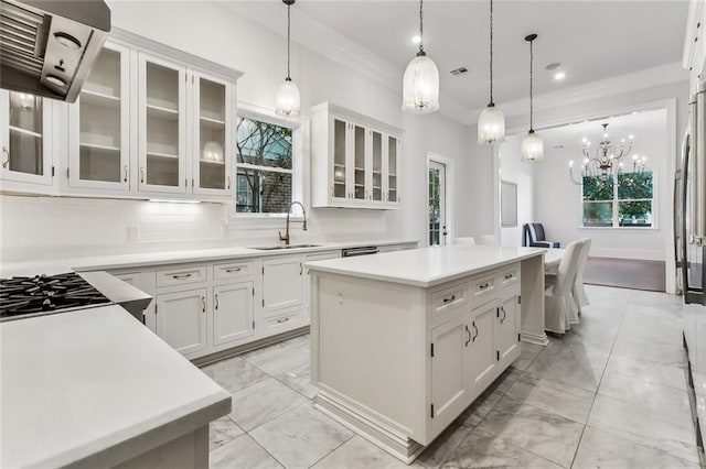 kitchen featuring pendant lighting, extractor fan, and white cabinetry