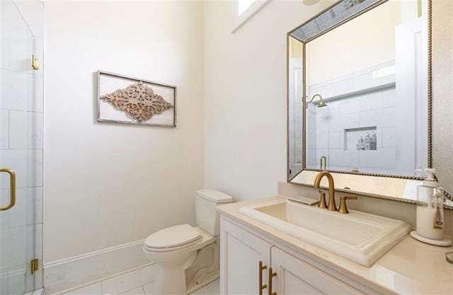 bathroom with vanity, a shower with shower door, toilet, and tile patterned flooring