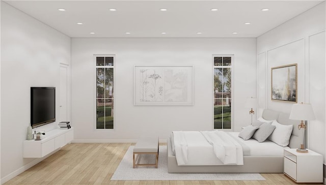 bedroom featuring multiple windows and light hardwood / wood-style floors