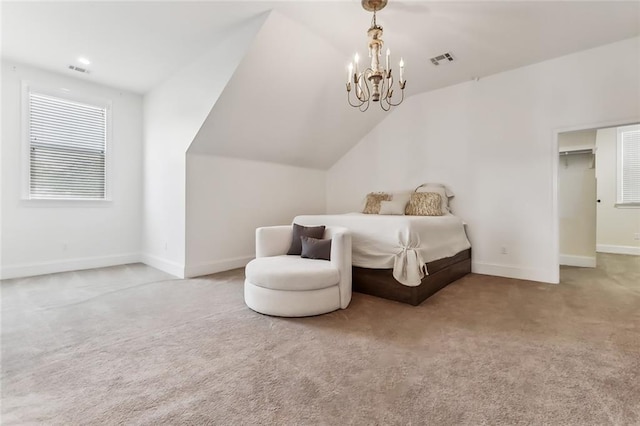 bedroom featuring a notable chandelier, vaulted ceiling, a spacious closet, and carpet flooring