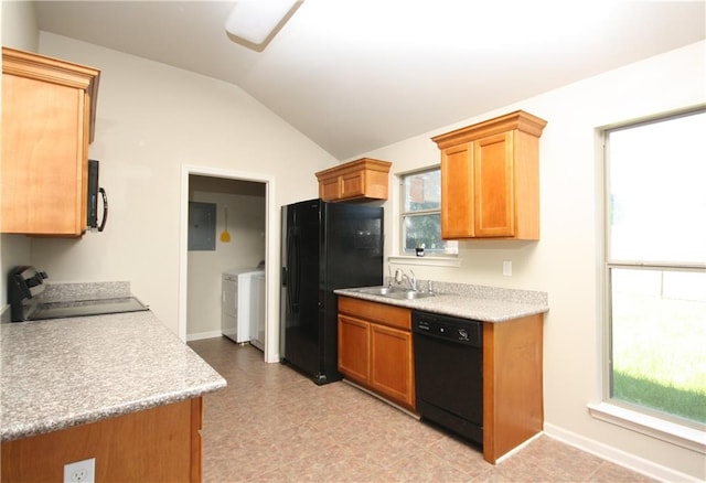 kitchen featuring electric panel, sink, vaulted ceiling, black appliances, and washing machine and dryer