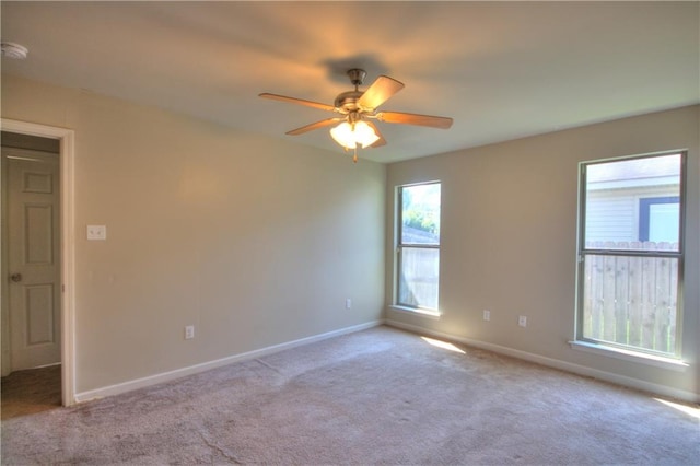 carpeted spare room with ceiling fan