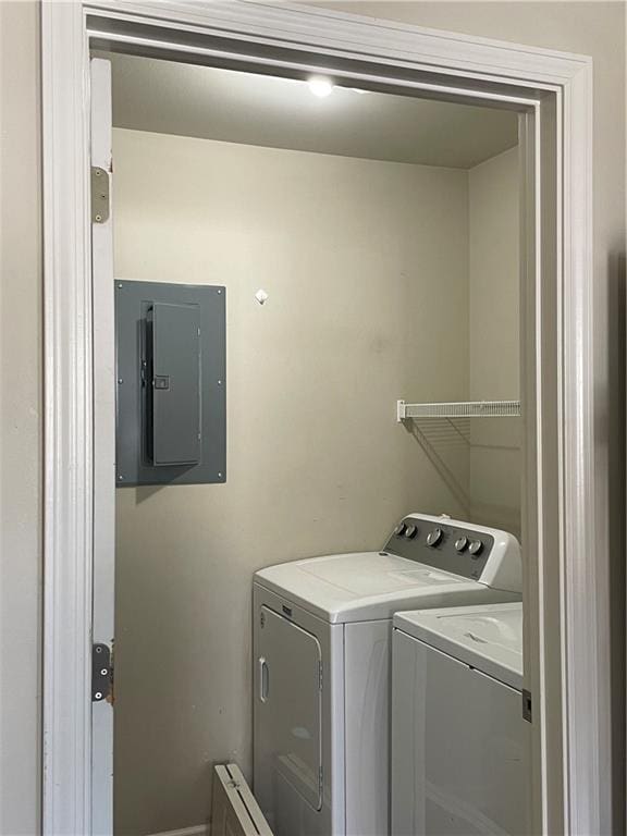 washroom with electric panel and washing machine and dryer