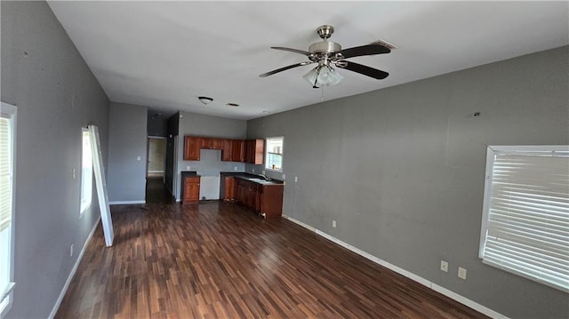 kitchen featuring ceiling fan, dark hardwood / wood-style floors, and sink