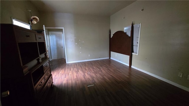 unfurnished living room with dark wood-type flooring