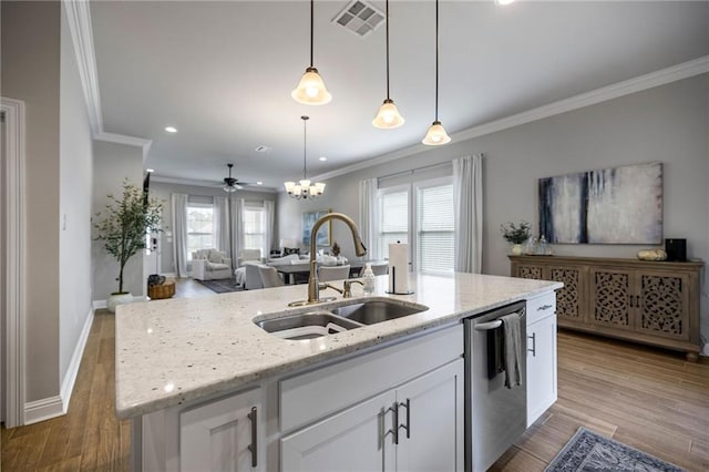 kitchen with white cabinets, dishwasher, hardwood / wood-style flooring, and sink