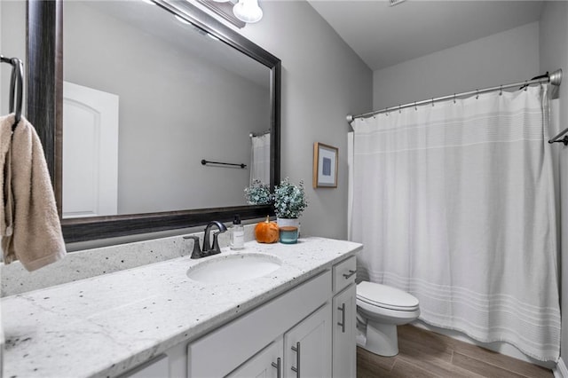 bathroom with wood-type flooring, vanity, toilet, and a shower with shower curtain