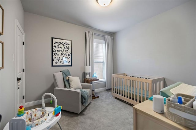 bedroom featuring a crib and light colored carpet