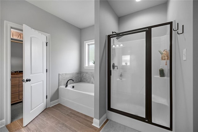 bathroom with separate shower and tub and hardwood / wood-style floors