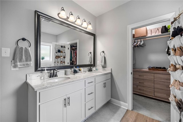 bathroom with wood-type flooring and vanity