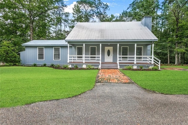 view of front of home with a porch and a front yard