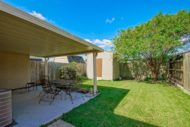 view of yard with cooling unit, a storage shed, and a patio area