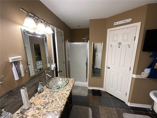 bathroom featuring a shower with door, vanity, and tile patterned floors