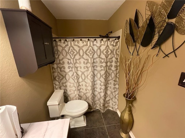 bathroom featuring a shower with curtain, tile patterned flooring, and toilet