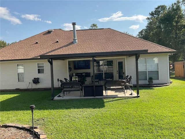 back of property with a lawn and a patio area