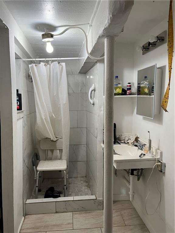 bathroom with sink and a shower with curtain