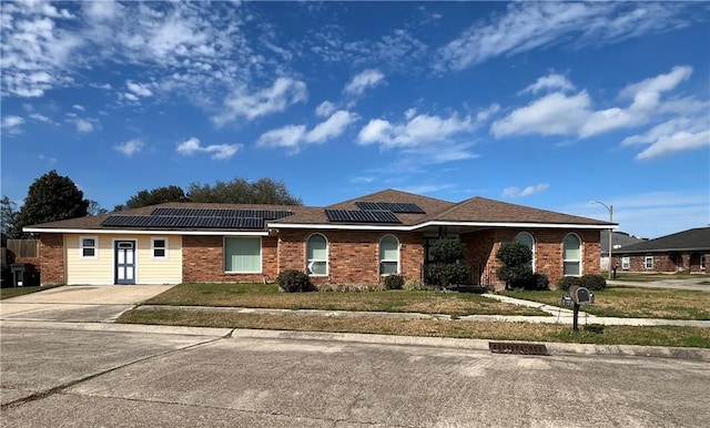 single story home featuring solar panels