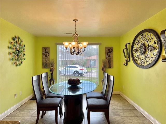 dining space featuring an inviting chandelier and light tile patterned flooring