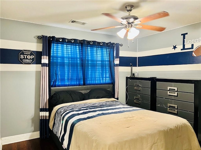 bedroom with ceiling fan and dark hardwood / wood-style flooring