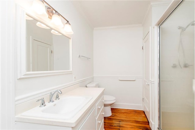 bathroom featuring vanity, an enclosed shower, wood-type flooring, crown molding, and toilet