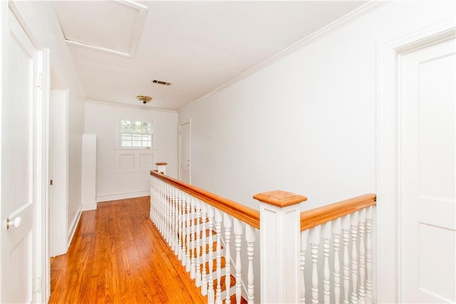 corridor with hardwood / wood-style flooring and crown molding