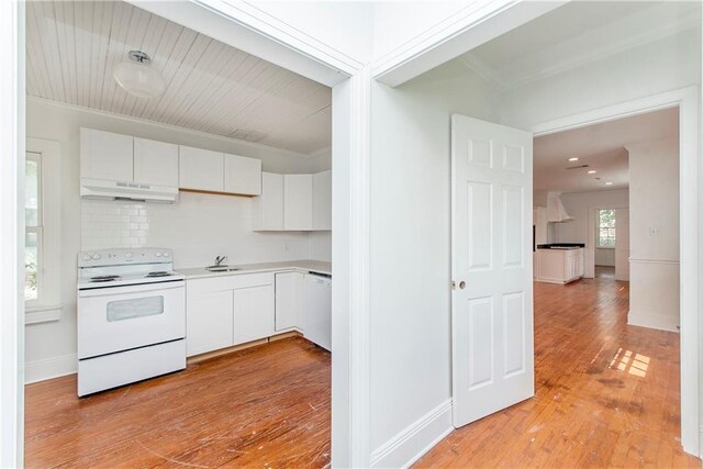 kitchen featuring white cabinetry, light hardwood / wood-style flooring, white appliances, extractor fan, and ornamental molding