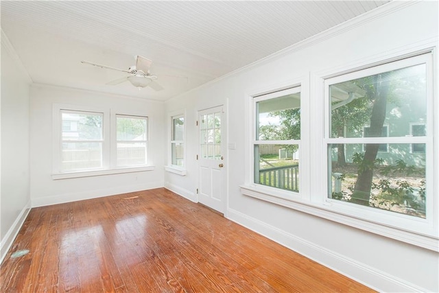 unfurnished sunroom with ceiling fan and a healthy amount of sunlight