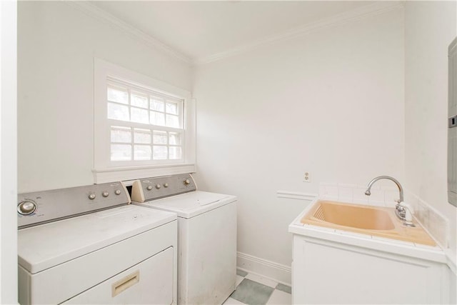 laundry room featuring washer and clothes dryer, crown molding, and sink