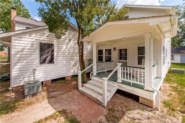 rear view of property featuring covered porch and central air condition unit