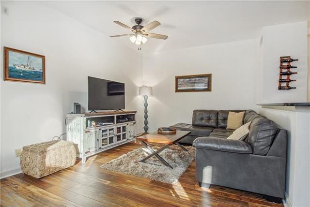 living room with hardwood / wood-style flooring and ceiling fan