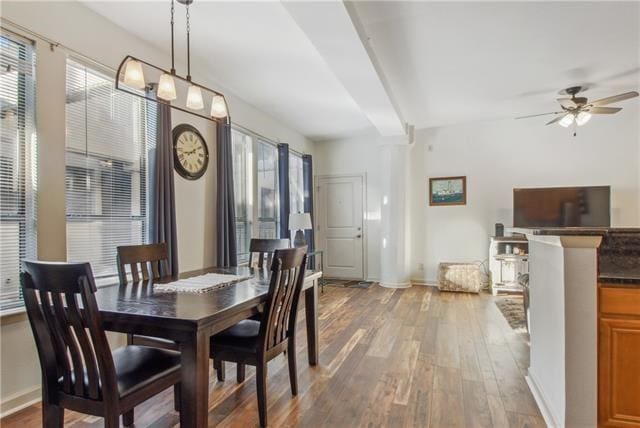 dining room featuring beamed ceiling, hardwood / wood-style flooring, and ceiling fan