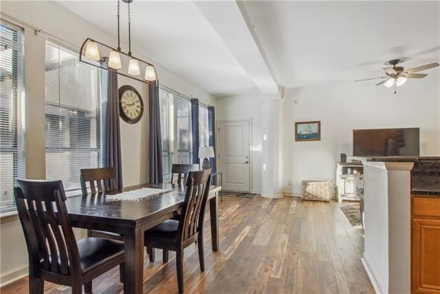 333 Julia St Unit 508, New Orleans, LA 70130 - dining space featuring decorative columns, light wood-style flooring, ceiling fan, and baseboards