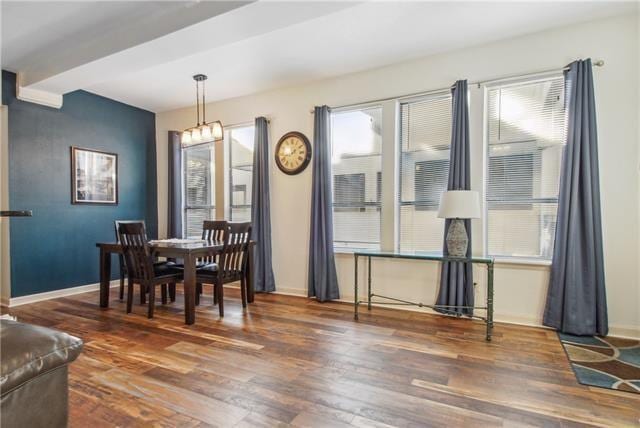 333 Julia St Unit 508, New Orleans, LA 70130 - dining space with wood finished floors, baseboards, and a chandelier