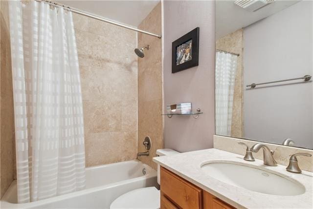 full bathroom with vanity, toilet, and shower / tub combo