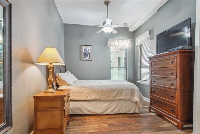 333 Julia St Unit 508, New Orleans, LA 70130 - bedroom with wood finished floors, baseboards, and ceiling fan