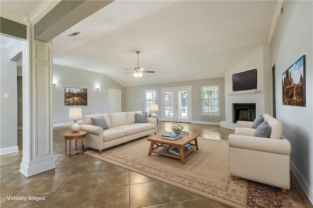 living room featuring ceiling fan, a large fireplace, tile patterned floors, crown molding, and lofted ceiling