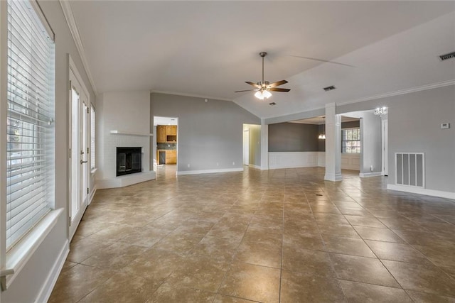 unfurnished living room featuring ceiling fan, a fireplace, vaulted ceiling, and ornamental molding