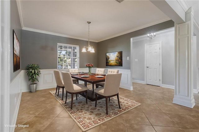 tiled dining room with a chandelier and ornamental molding