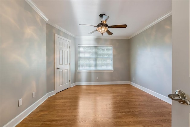 unfurnished room with ceiling fan, wood-type flooring, and crown molding