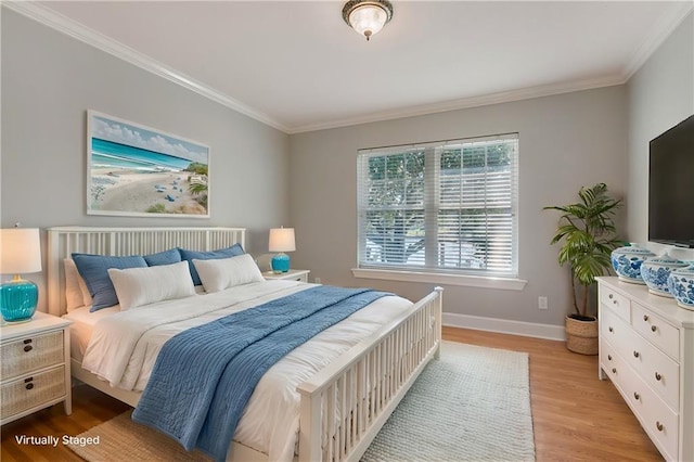 bedroom featuring light wood-type flooring and crown molding