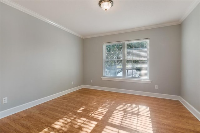 empty room featuring crown molding and light wood-type flooring